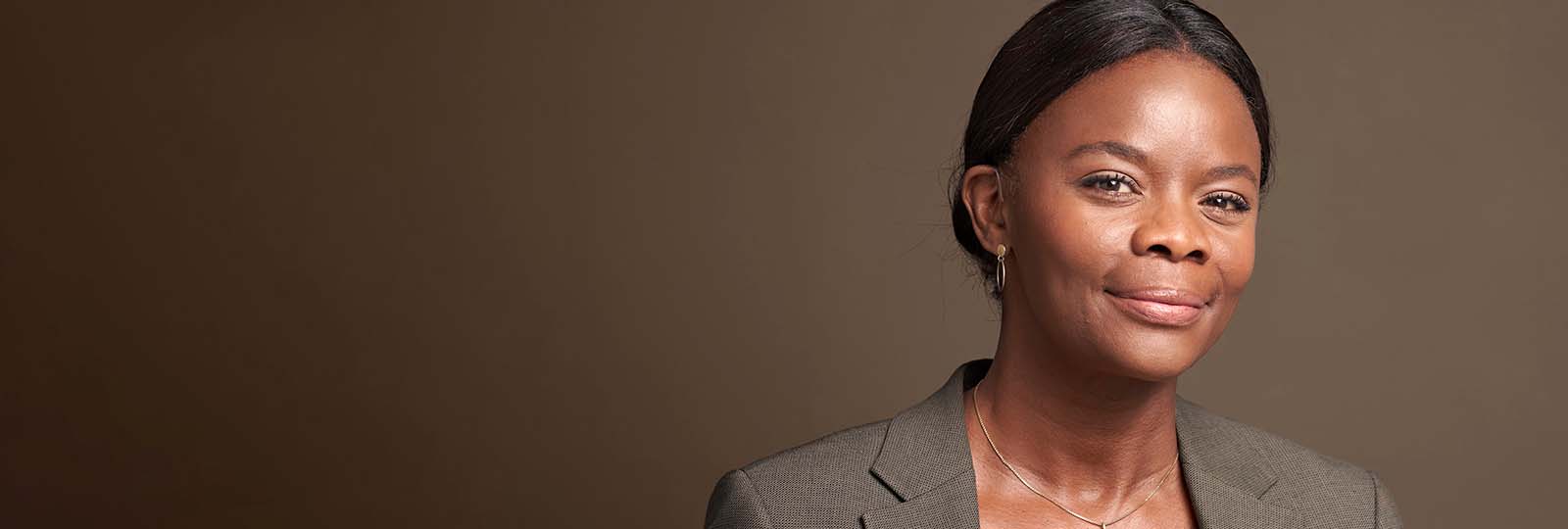 Woman smiling while wearing Rexton BiCore Rugged hearing aids