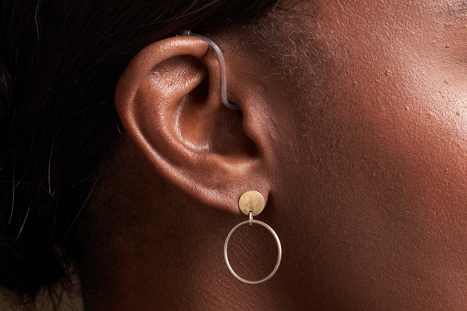 Woman wearing Rexton BiCore Rugged hearing aids