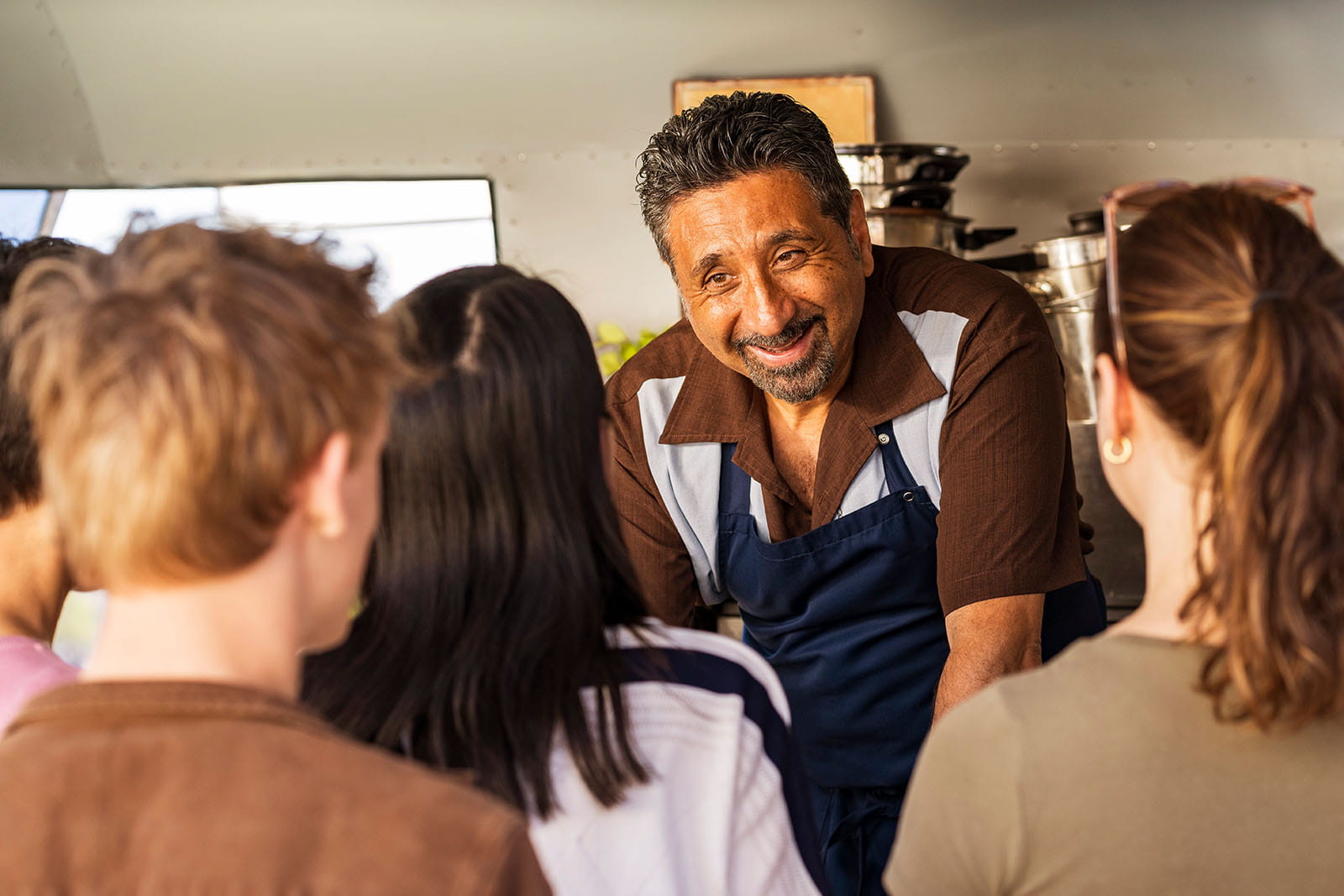 Man talking to customers